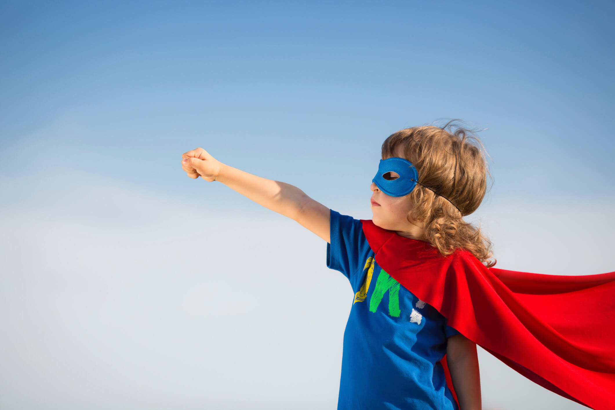 Child wearing superhero costume